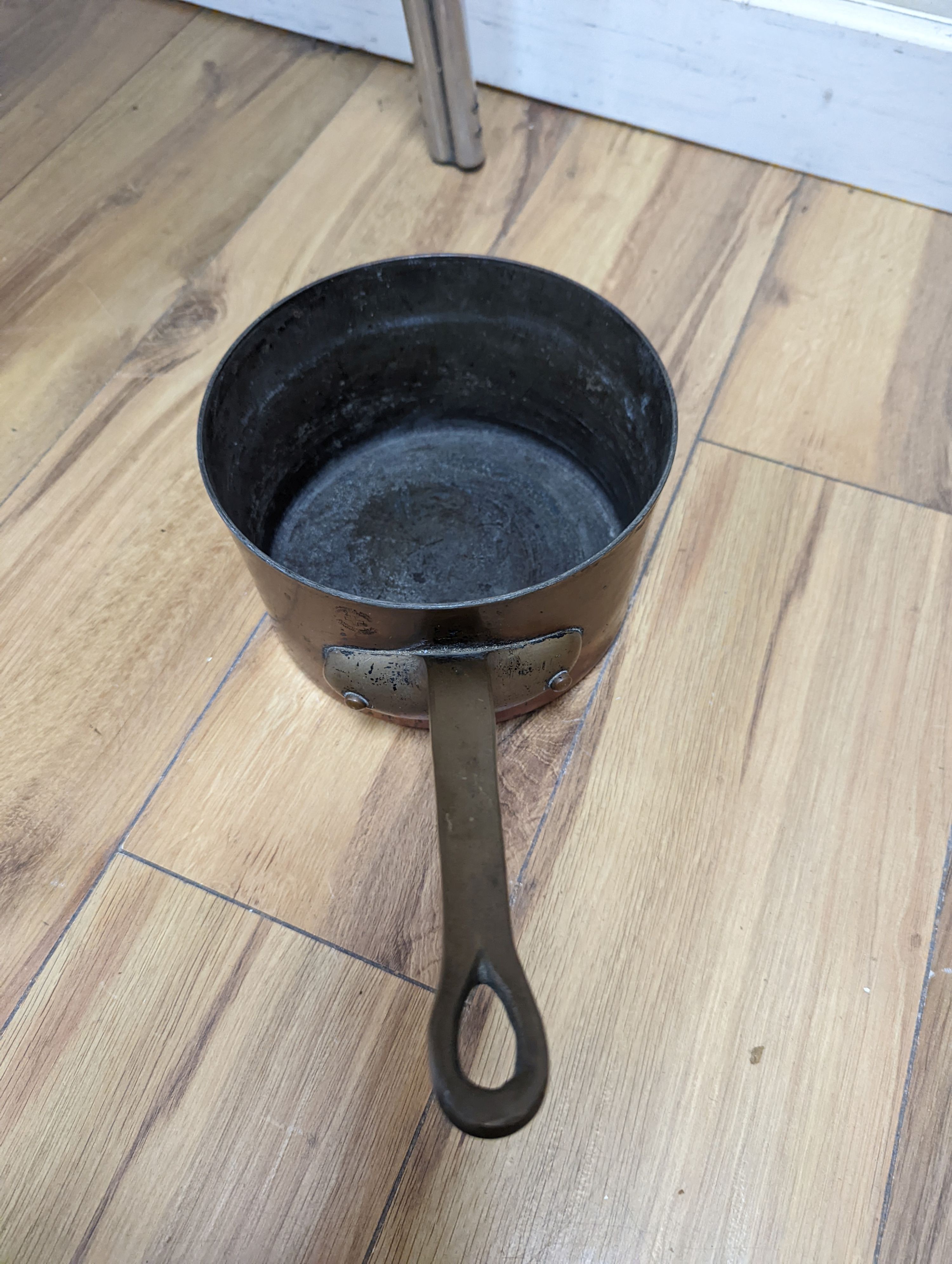 A group of three Jaeggi & Sons copper saucepans